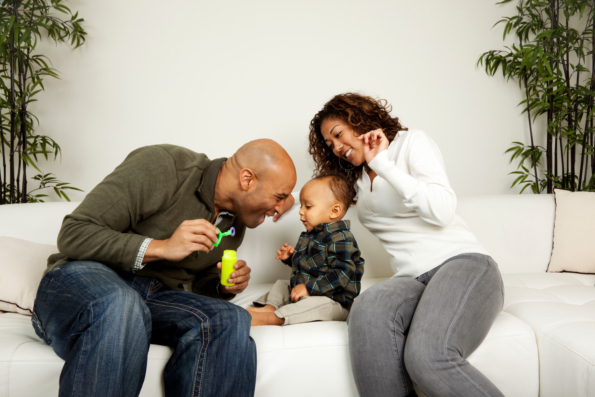 Happy Family African American playing with their baby boy home